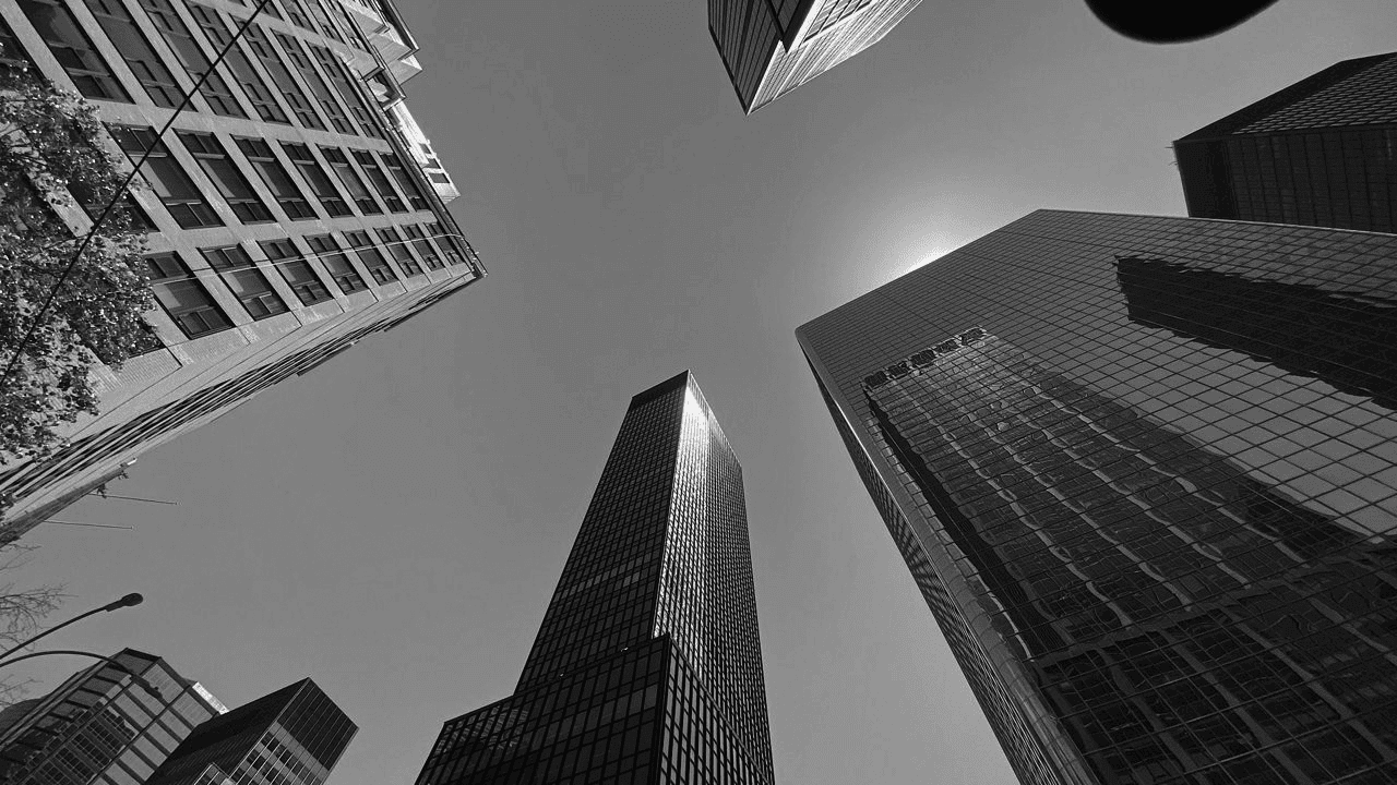 Black and white photo of skyscrapers in new york city.