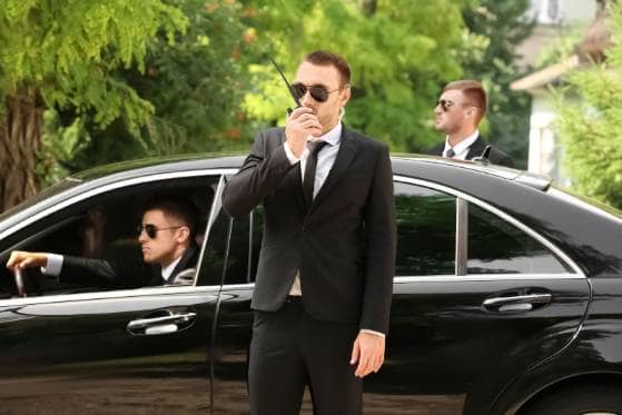 A group of men standing next to the best car service.