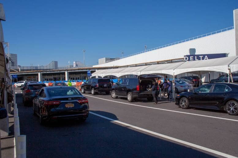 A fleet of cars parked in a parking lot, offering car service to Newark Airport from NJ.