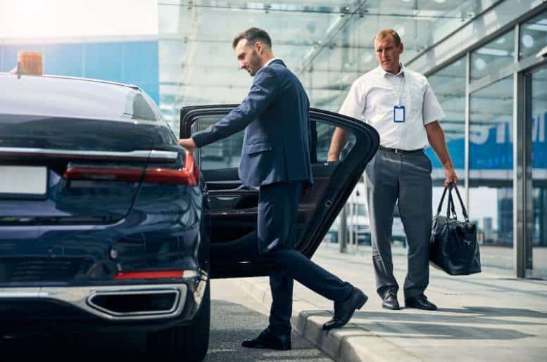 Two businessmen arriving at Newark Airport by car service.